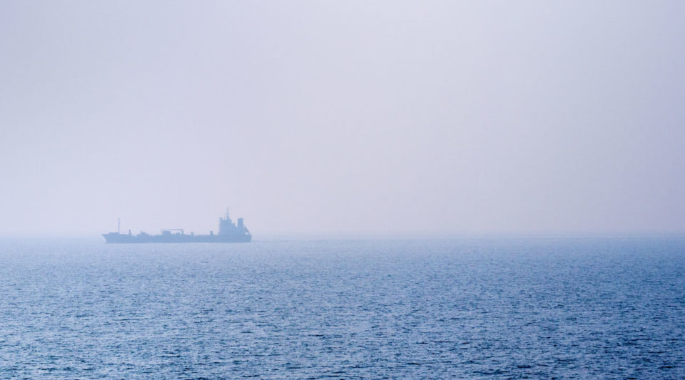 Ship on a foggy sea, early morning