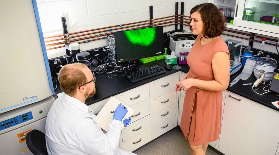 Pinar and graduate student in lab