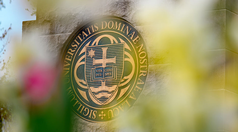 The University seal on the south entrance to campus at the end of Notre Dame Avenue
