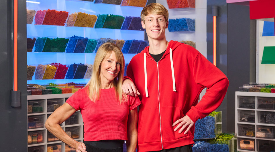 Luke Horwath and his mom, Anne, pose in matching red shirts.