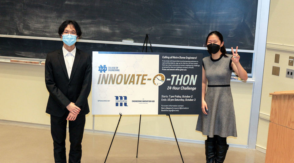 Innovate-o-thon participants standing in front of sign for competition