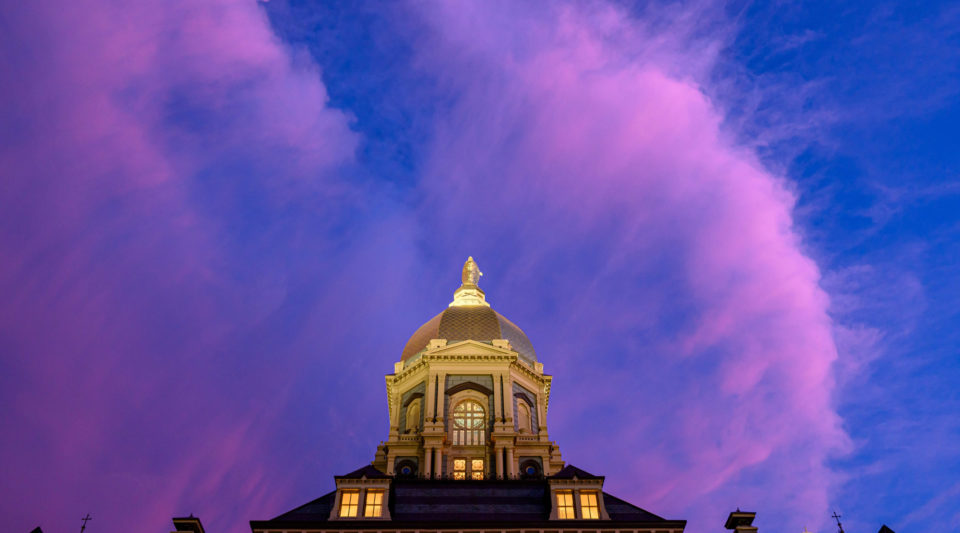 Main Building at dusk, clouds in sky appear pink